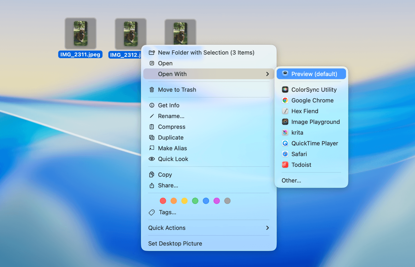 Three photos of a dog selected on a Mac Desktop, with the Preview option highlighted after right-clicking the selection